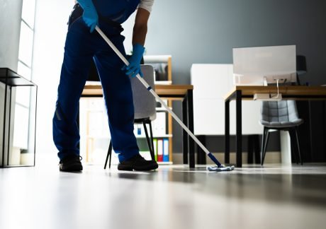 Male,Janitor,Mopping,Floor,In,Face,Mask,In,Office